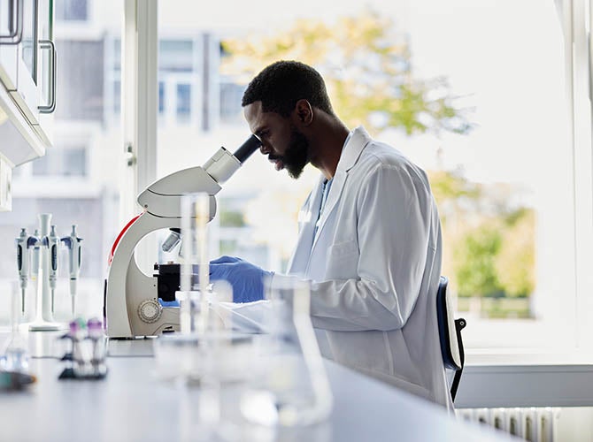 Man looking into a microscope