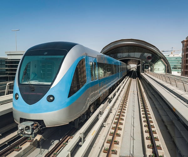 High speed blue and grey train waiting at an empty platform