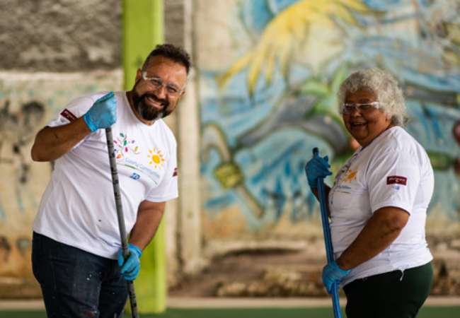 Two volunteers sweeping 