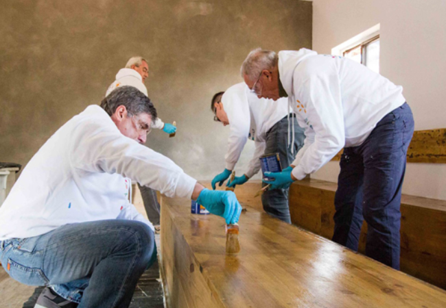 group of people staining wood 