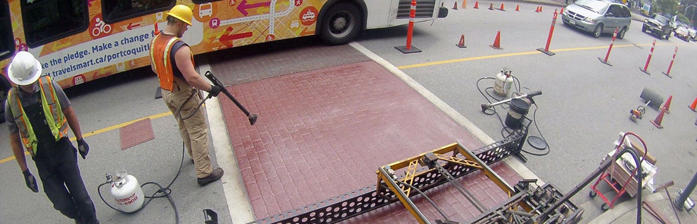 Worker applying product with heat torch