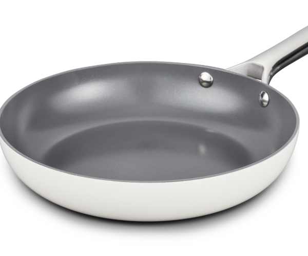 Frying pan coated in cream on the outside and a grey non-stick interior 