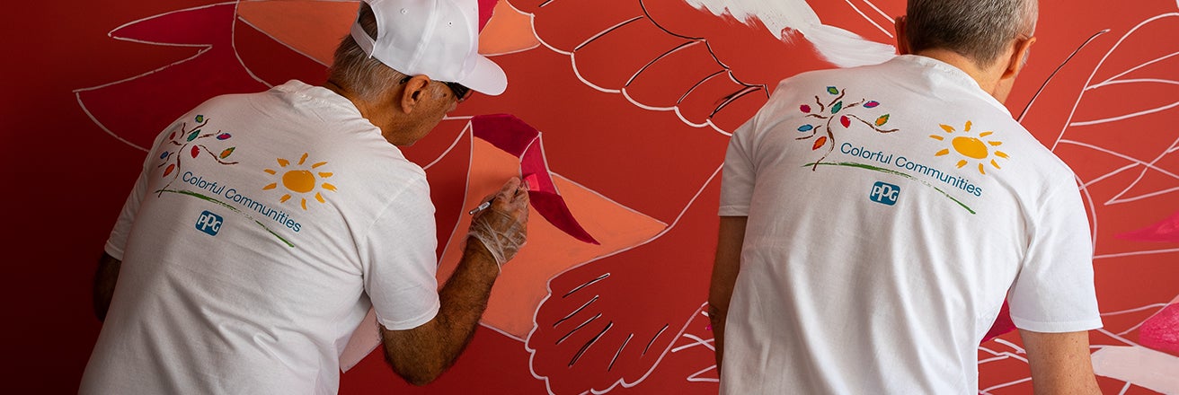 men painting red wall mural 