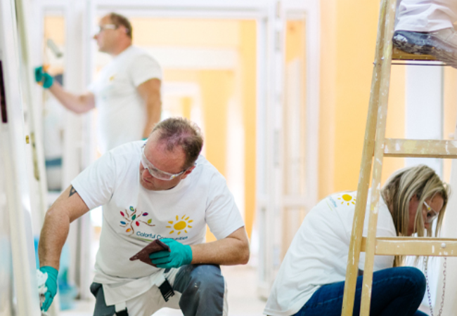 volunteers painting wall white