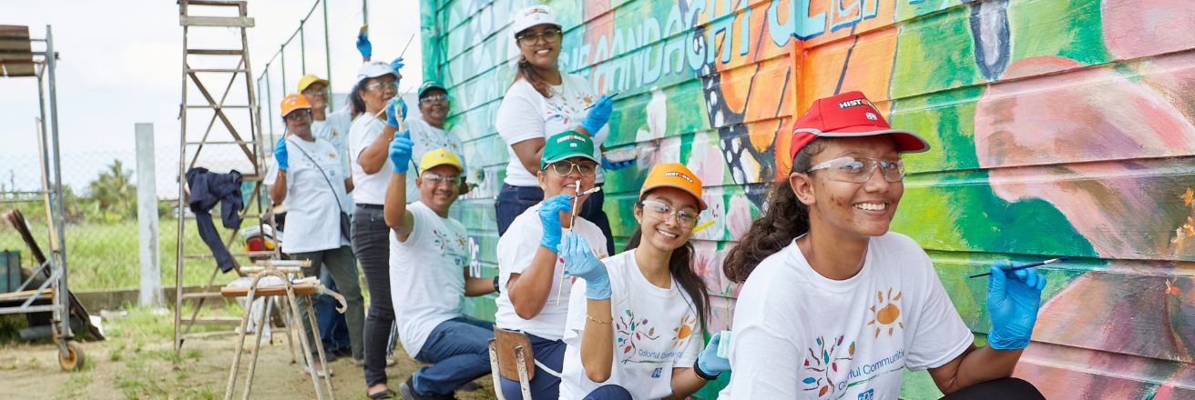 Volunteers painting mural