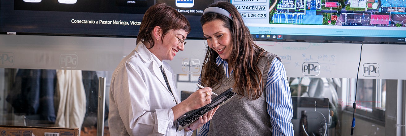 Two female workers discussing sustainability within PPG facilities