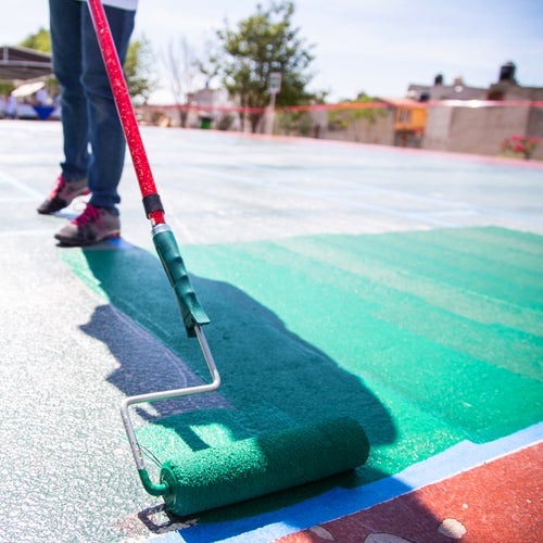 volunteer painting playground green 