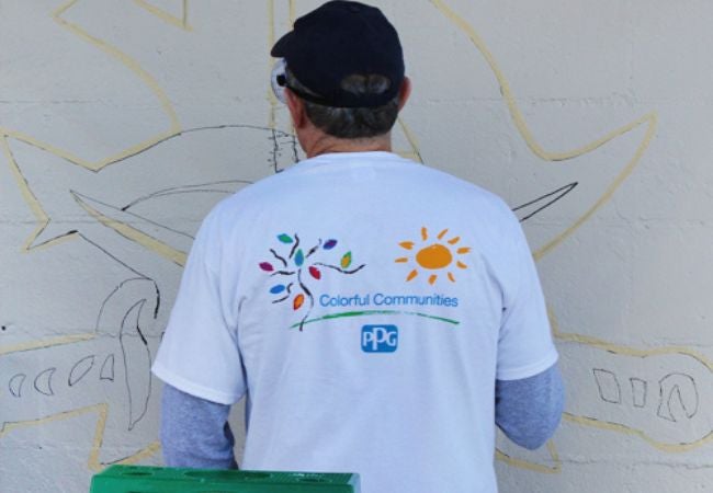 man sketching mural