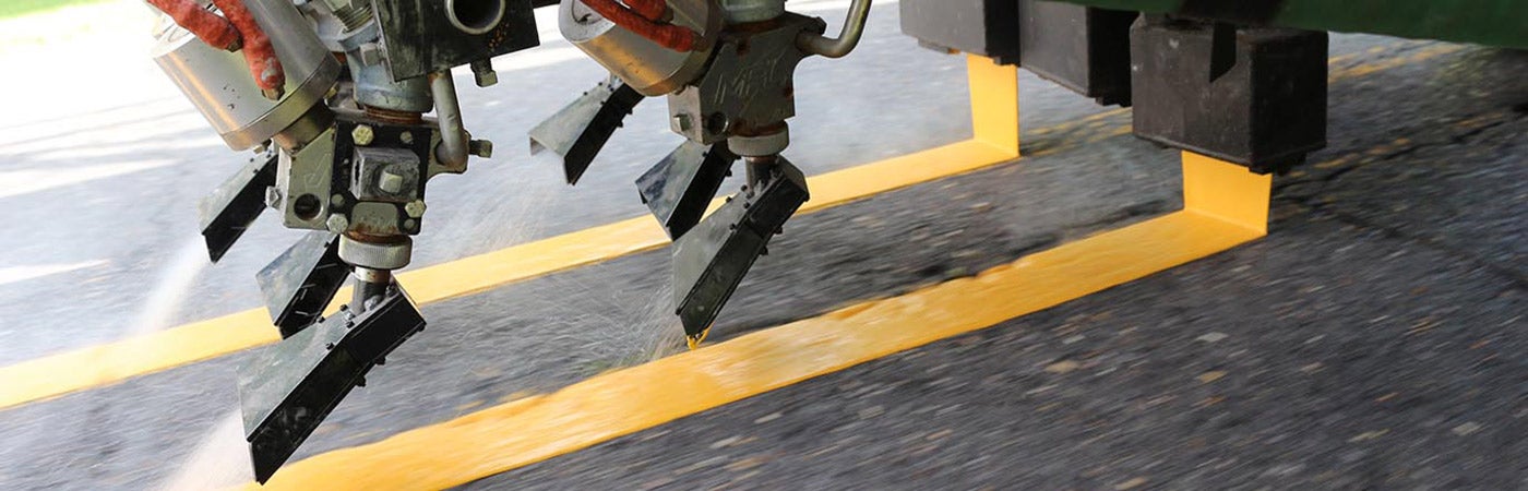 A paint truck applying paint to a roadway.