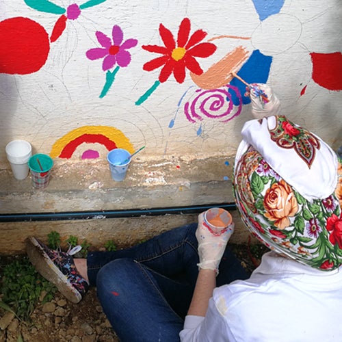 man painting colorful mural 