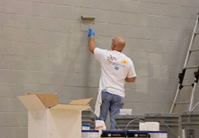 volunteer painting wall tan 