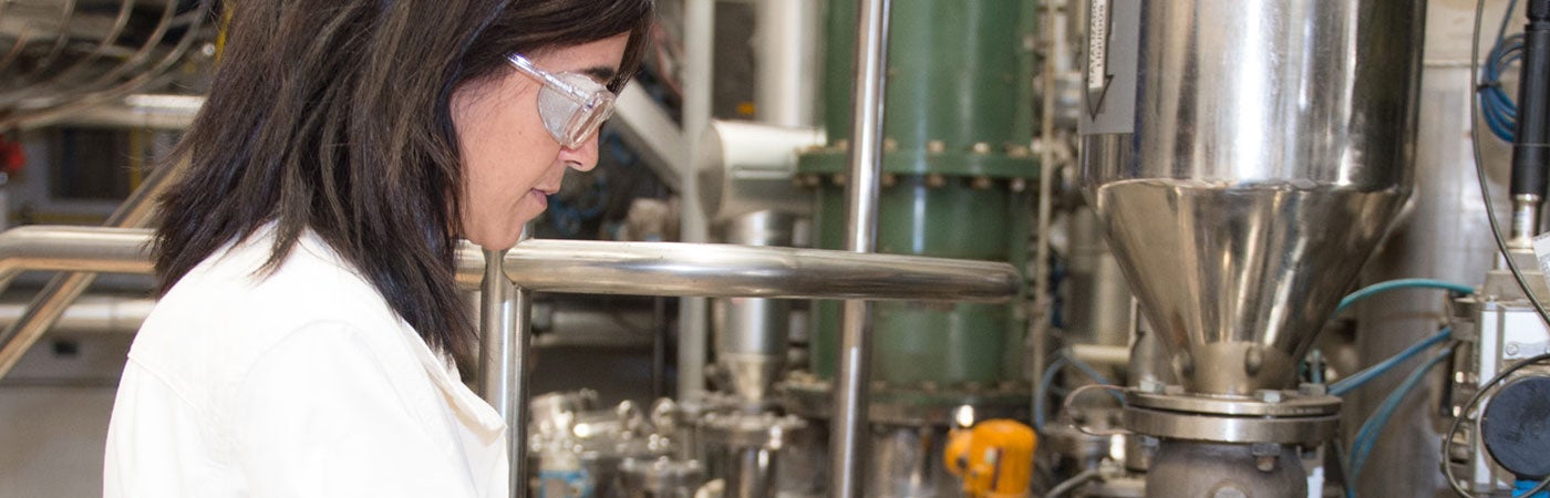 Woman in Science coat and goggles 