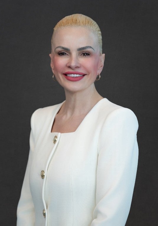 Irene Tasi portrait headshot wearing a white jacket