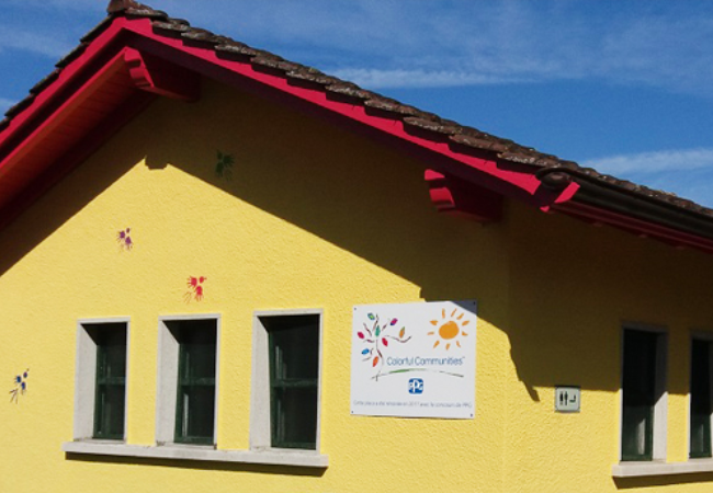 Yellow building with PPG Colorful Communities sign on it 