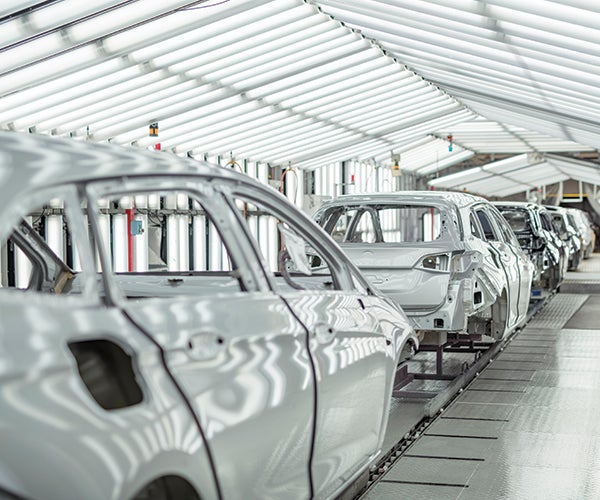 Line of cars being coated with PPG paint in factory