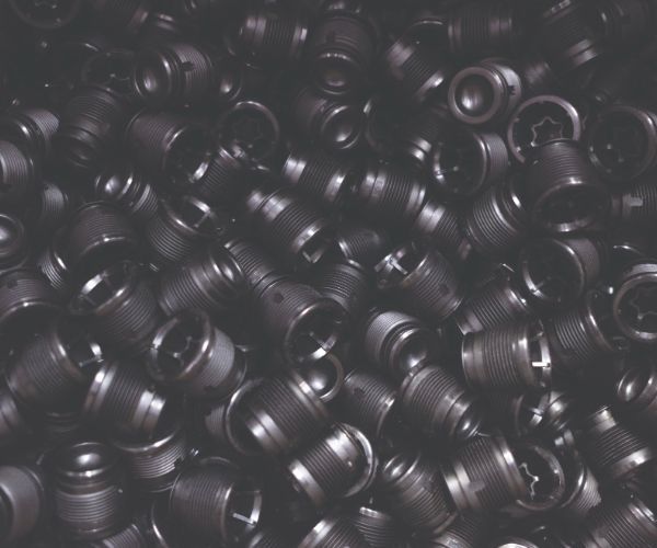 Close up view of a pile of black small parts