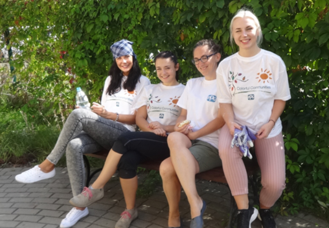 four volunteers taking a break on a bench 