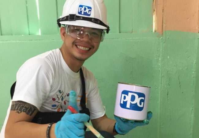 man holding paint can and paint brush