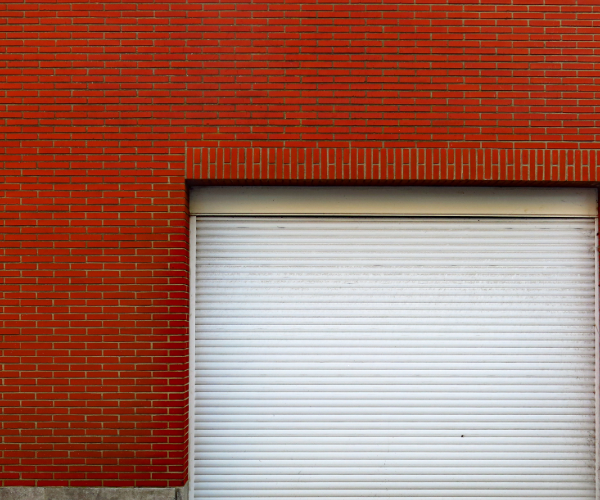 White rolling garage front on a red brickwork building