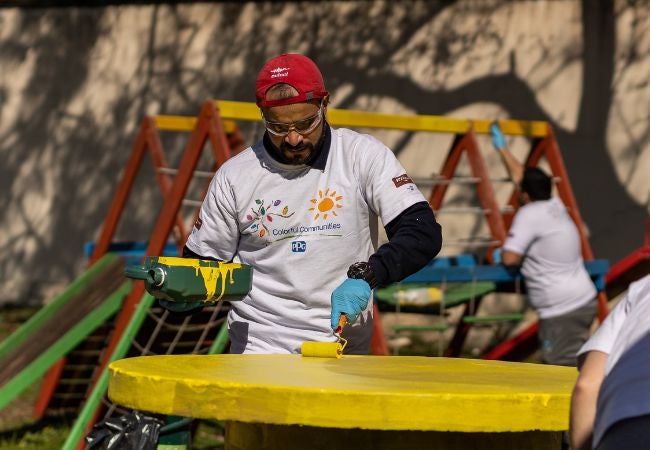 Man painting playground equipment