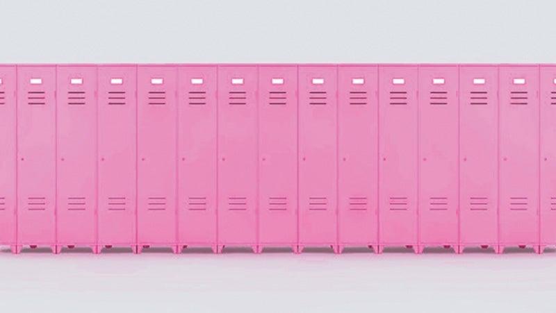 A continuous row of closed pink lockers with ventilation slots, set against a plain light background