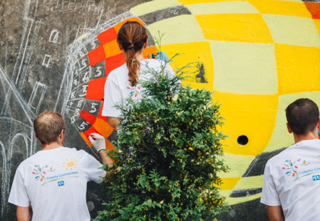 Three people painting a mural in Cieszyn, Poland 