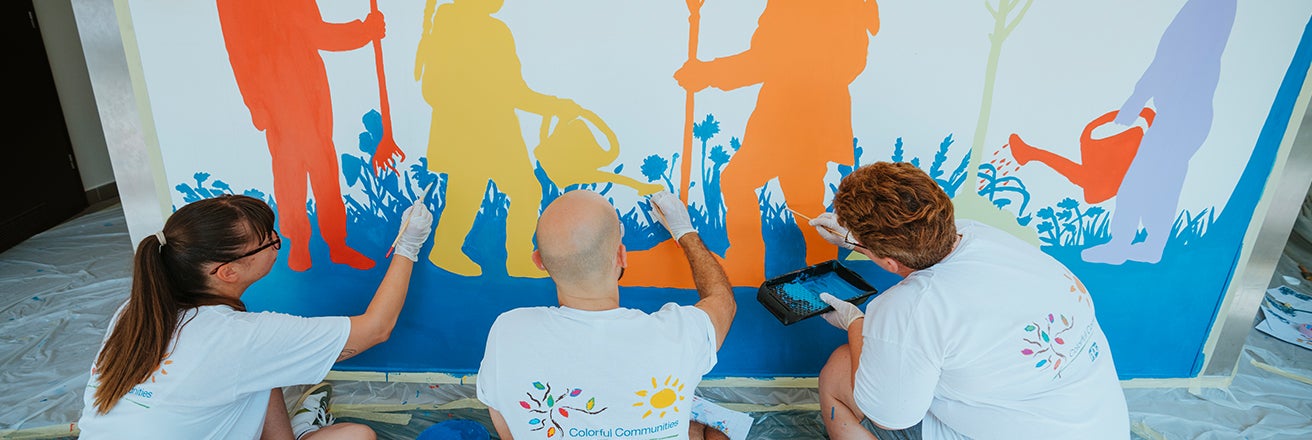 Volunteers painting mural as part of PPG Colorful Communities event