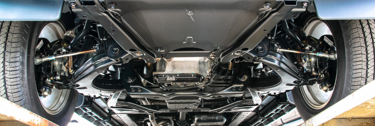 Car mounted on a ramp looking at the underbody of the chassis