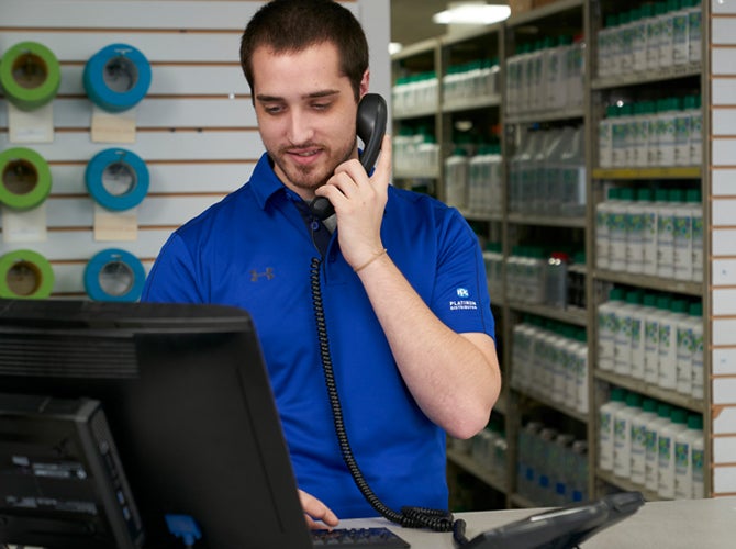 Male worker on phone in distribution center