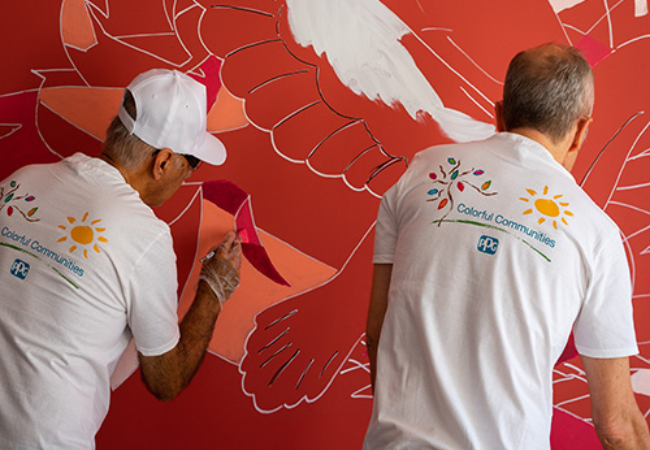 two men painting wall mural 