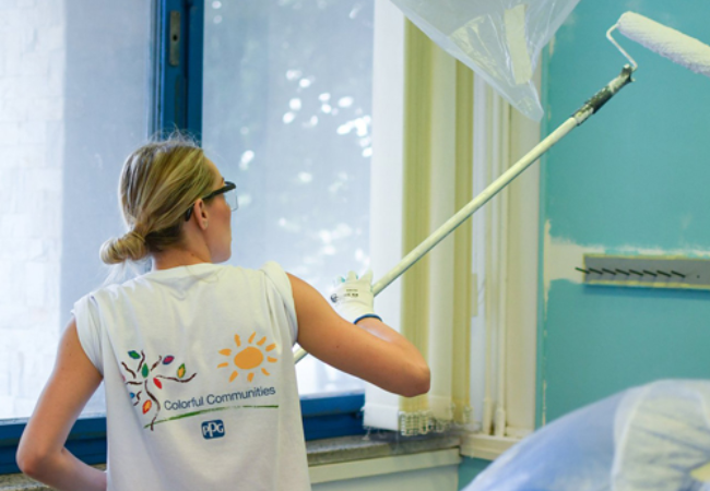 girl painting wall white 