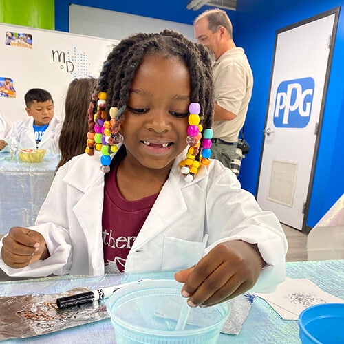 young kid doing science experiment 