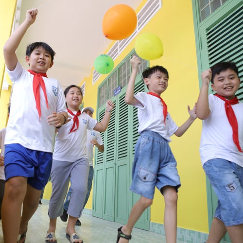 students dancing through a hallway 