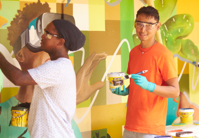 volunteers painting wall