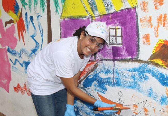 woman painting mural