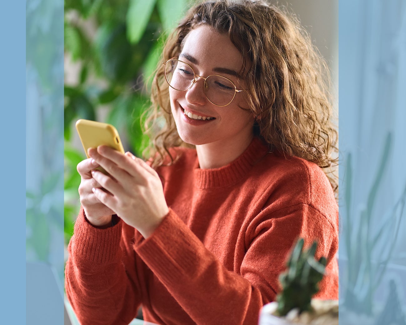 Jonge vrouw kijkt lachend op telefoon