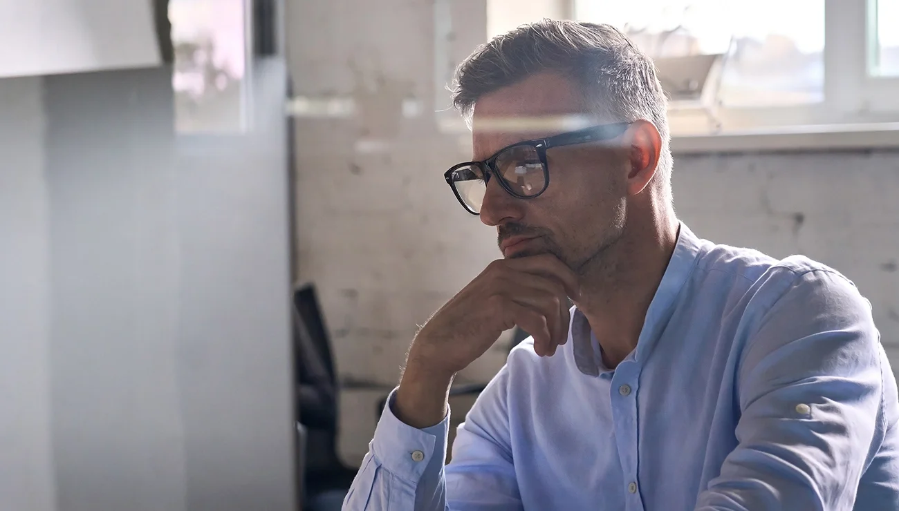 Man kijkt aandachtig naar zijn computerscherm