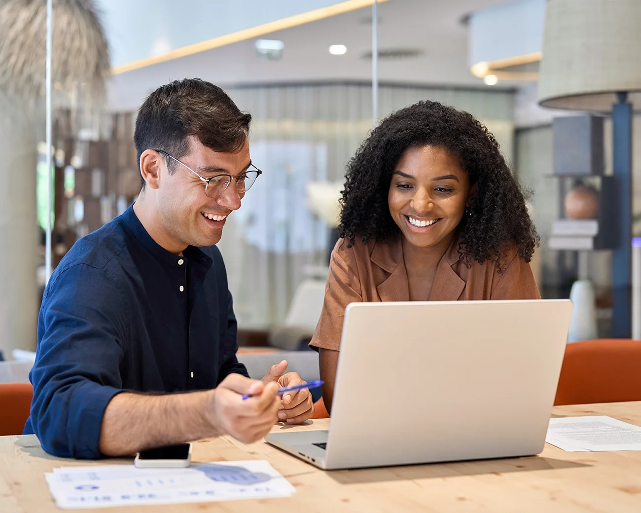 Lachende collega's kijkend naar laptop