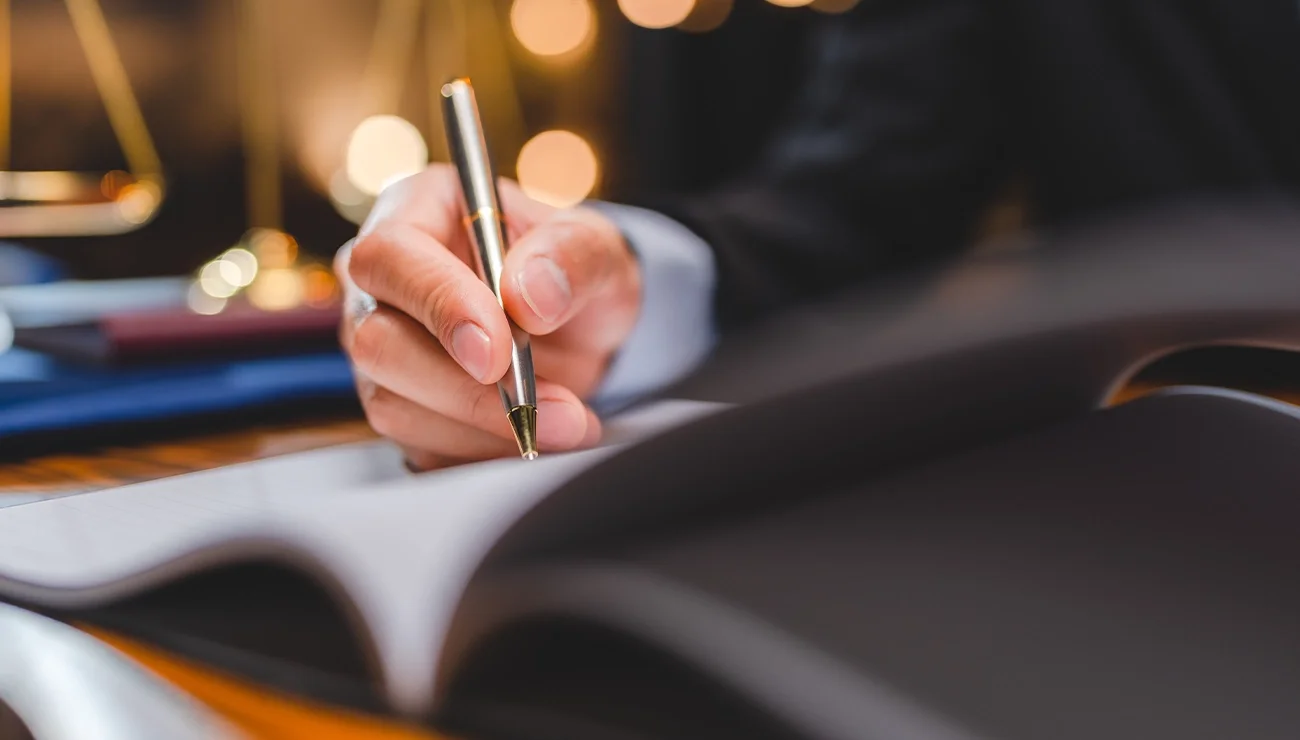 Persoon schrijft in een notitieboek