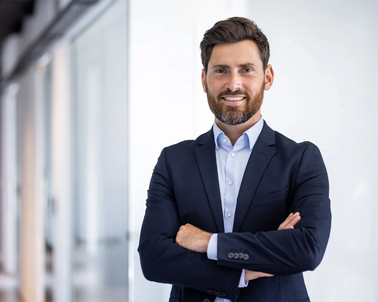 man in pak met armen over elkaar