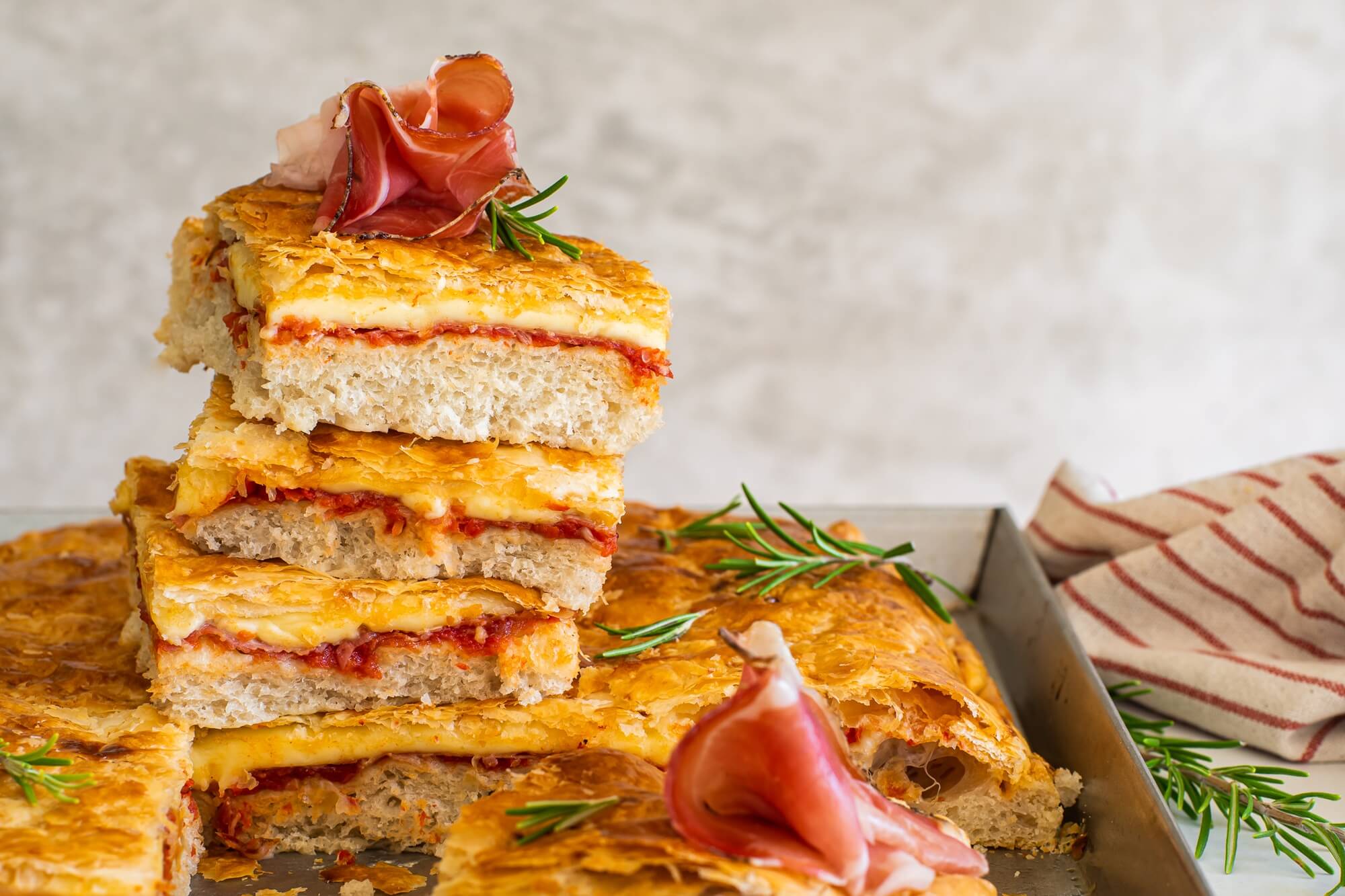 Pizza Parigina with Speck Alto Adige PGI, cheese and crispy puff pastry topping