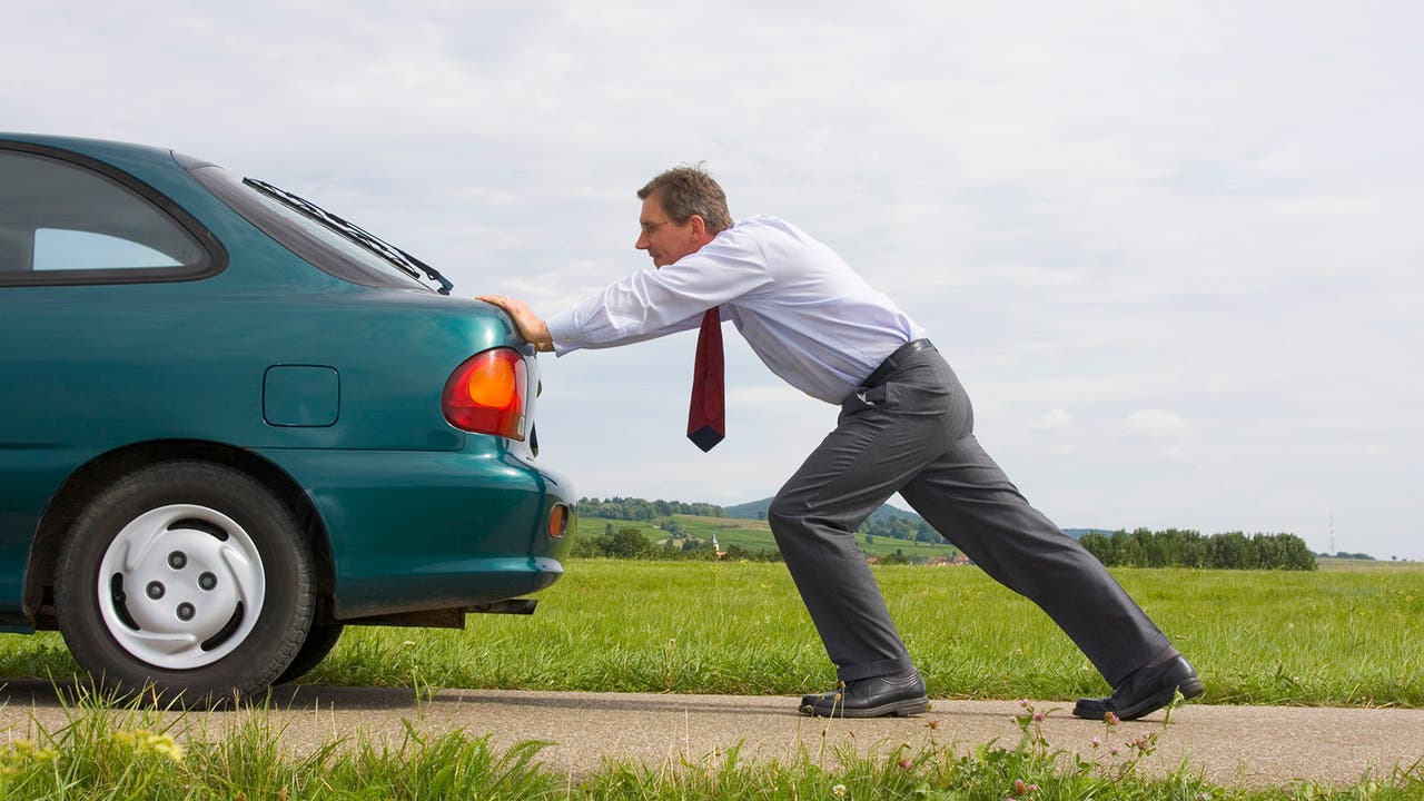 Man pushing car