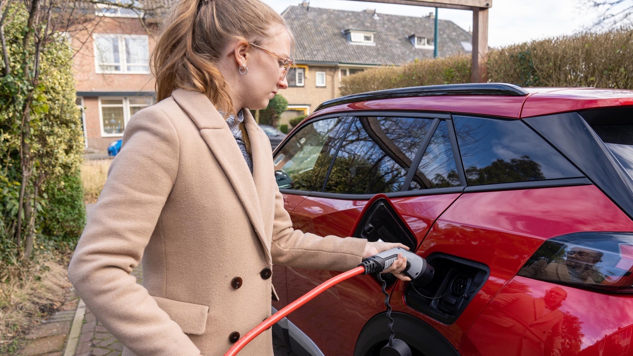 Woman charging electric car in the Netherlands