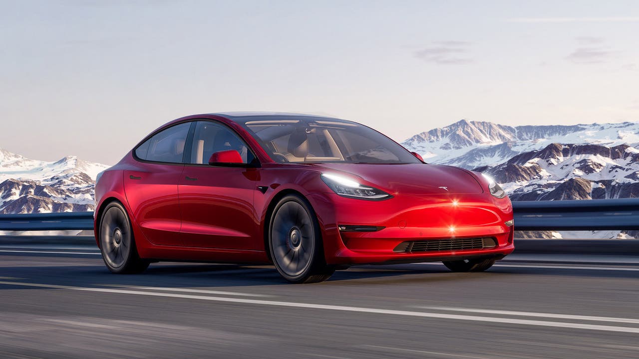 Tesla Model 3 in red – driving shot