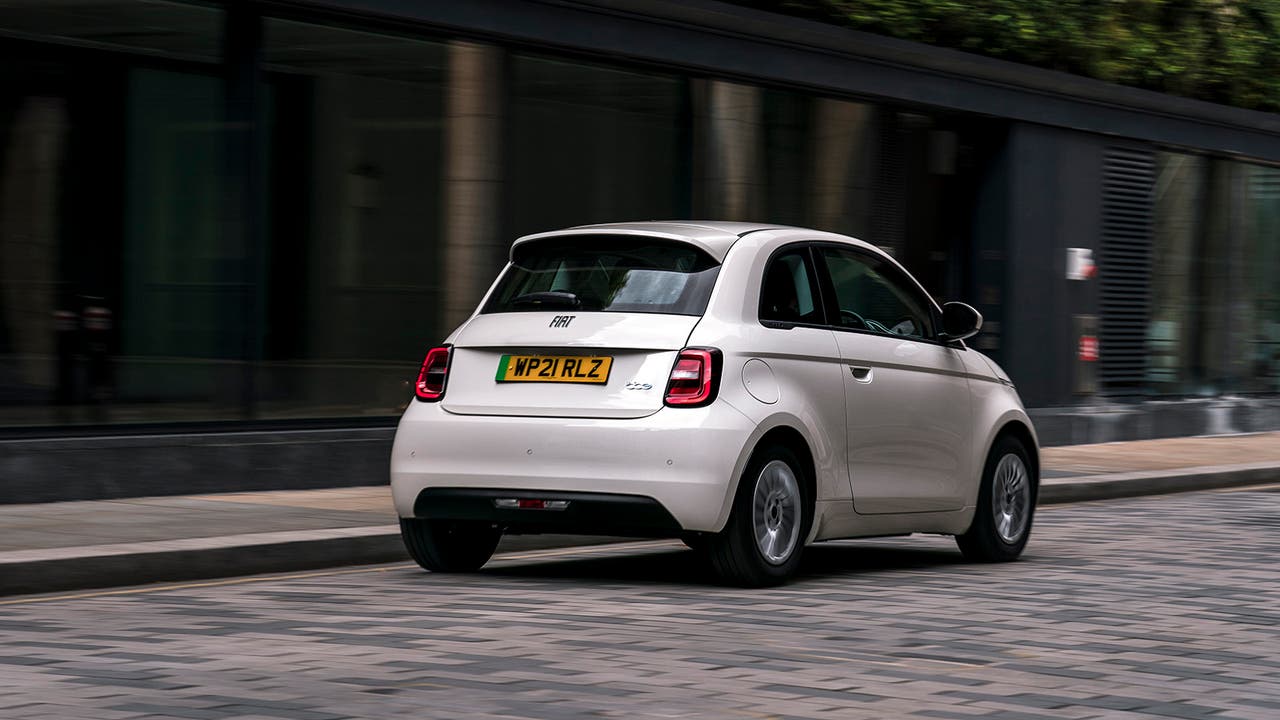 Fiat 500e in white rear three quarter driving shot