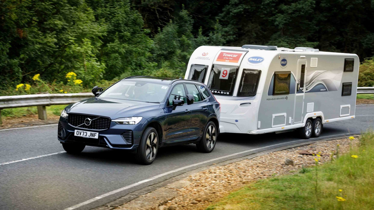 Volvo XC60 towing caravan up a hill