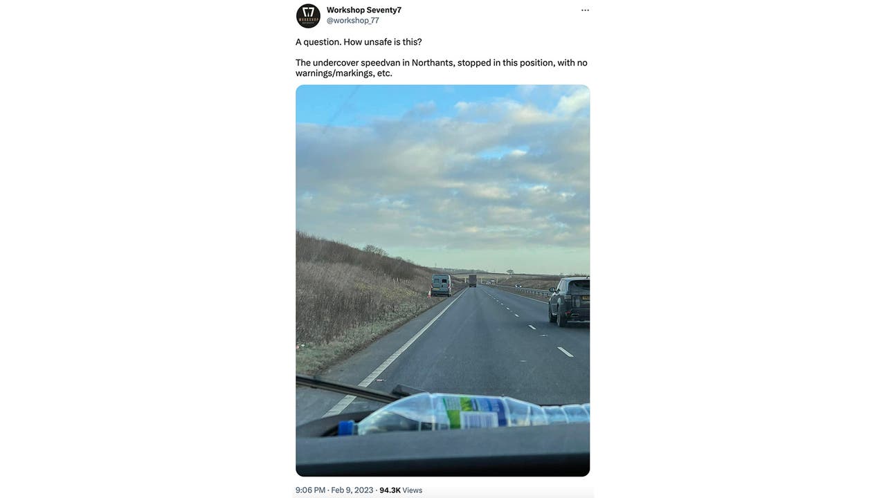A screenshot of a tweet by Workshop Seventy7 showing a grey unmarked police speed van by the side of a two-lane dual carriageway