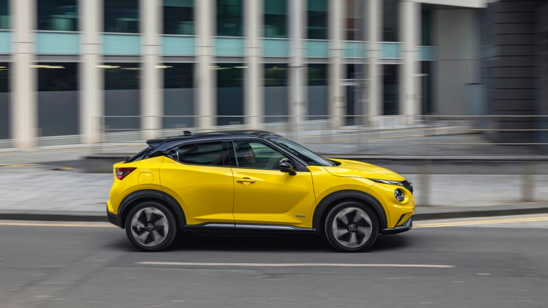 Yellow Nissan Juke driving side view