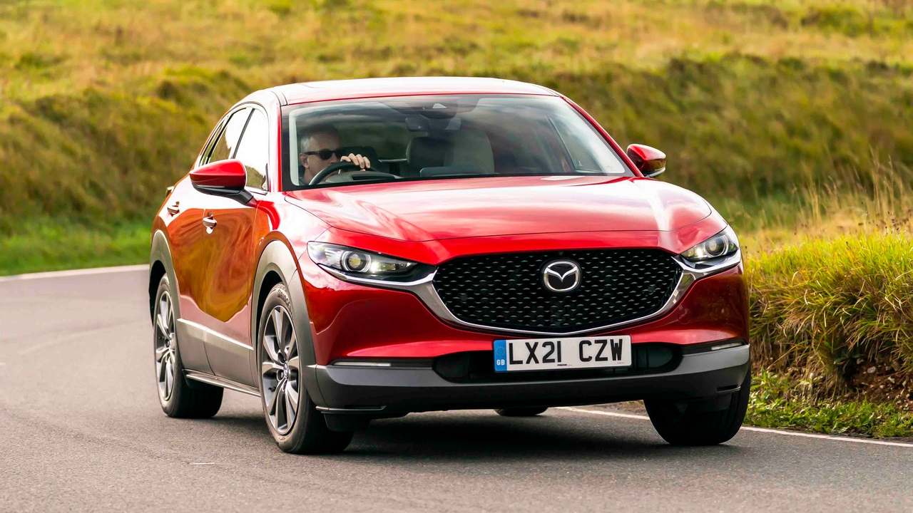 Red Mazda CX-30 driving