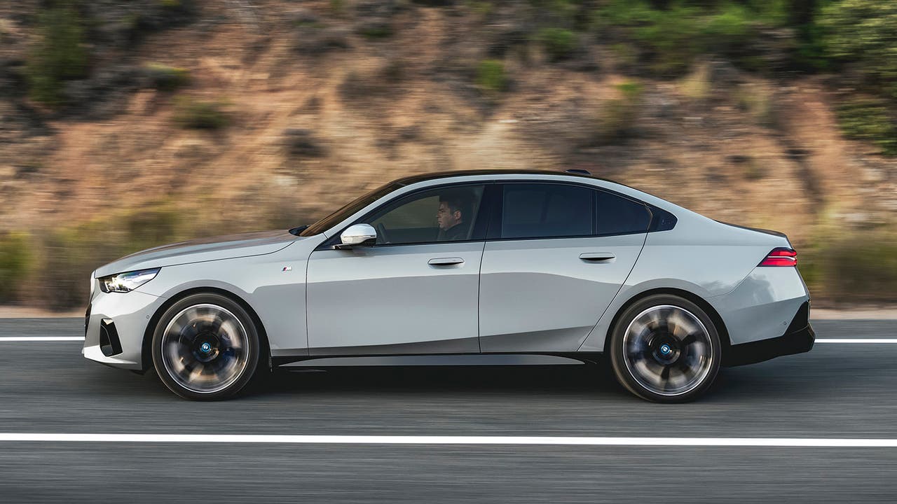 New BMW i5 in grey, side driving shot
